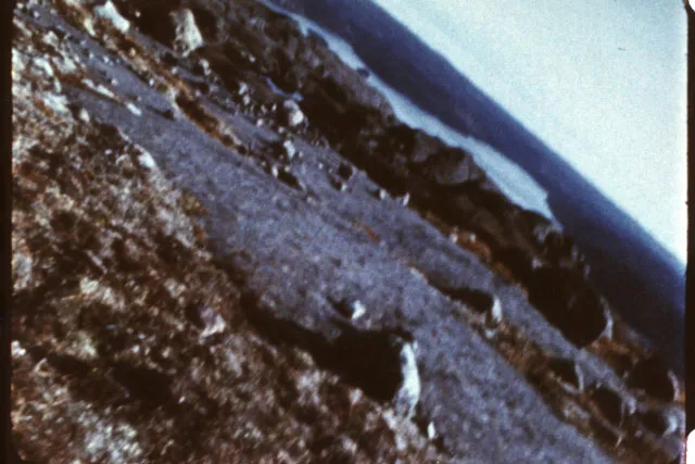 A vintage film still of a tilted rocky beach. 