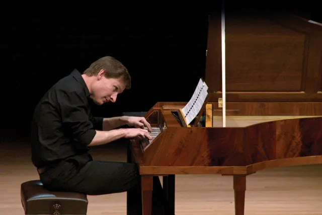 kristian bezeudenhout playing piano on the concert hall stage. 