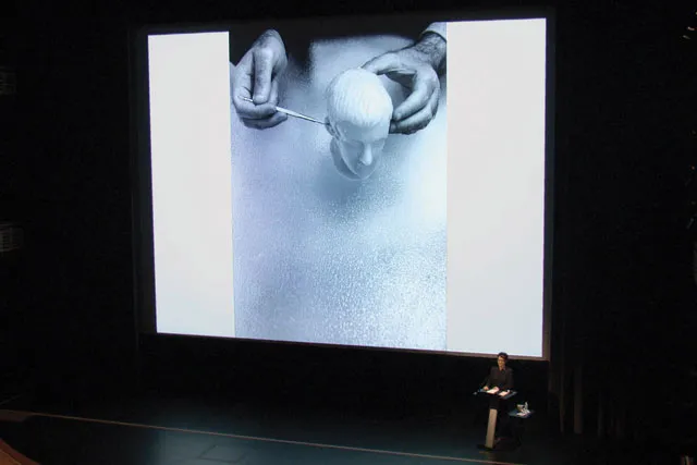avital ronell on stage in lecture. 