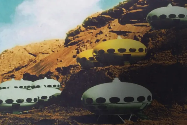 Nine UFO type crafts placed through out a desert landscape. 