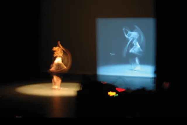  A blurred dancer twirling infant of a gray projection of themselves. 