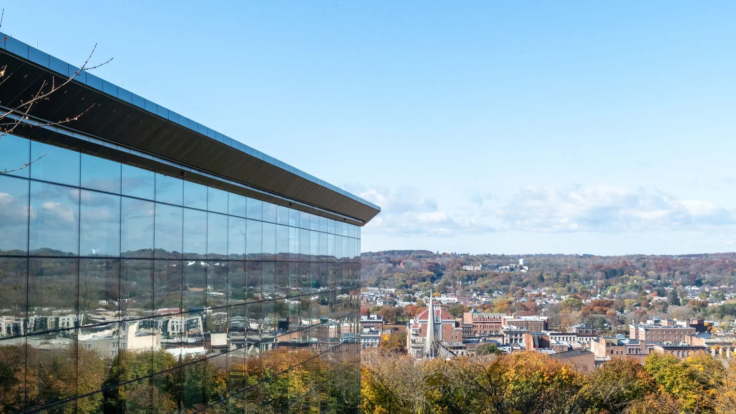 looking west across the hudson valley from the east entrance of EMPAC with the city of troy reflected in the north glass façade