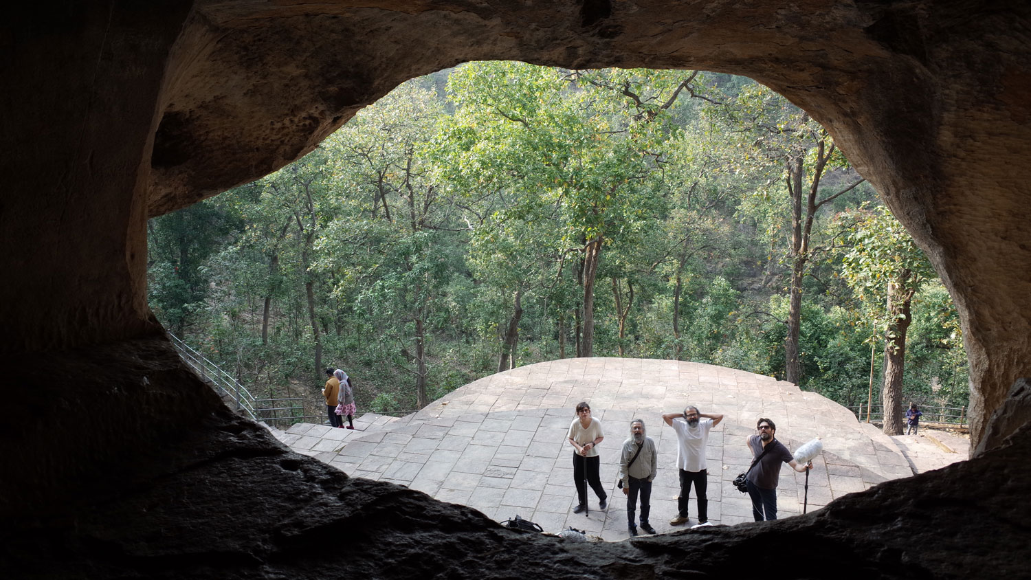 for people looking at the camera through a huge cave opening, sita benga. 