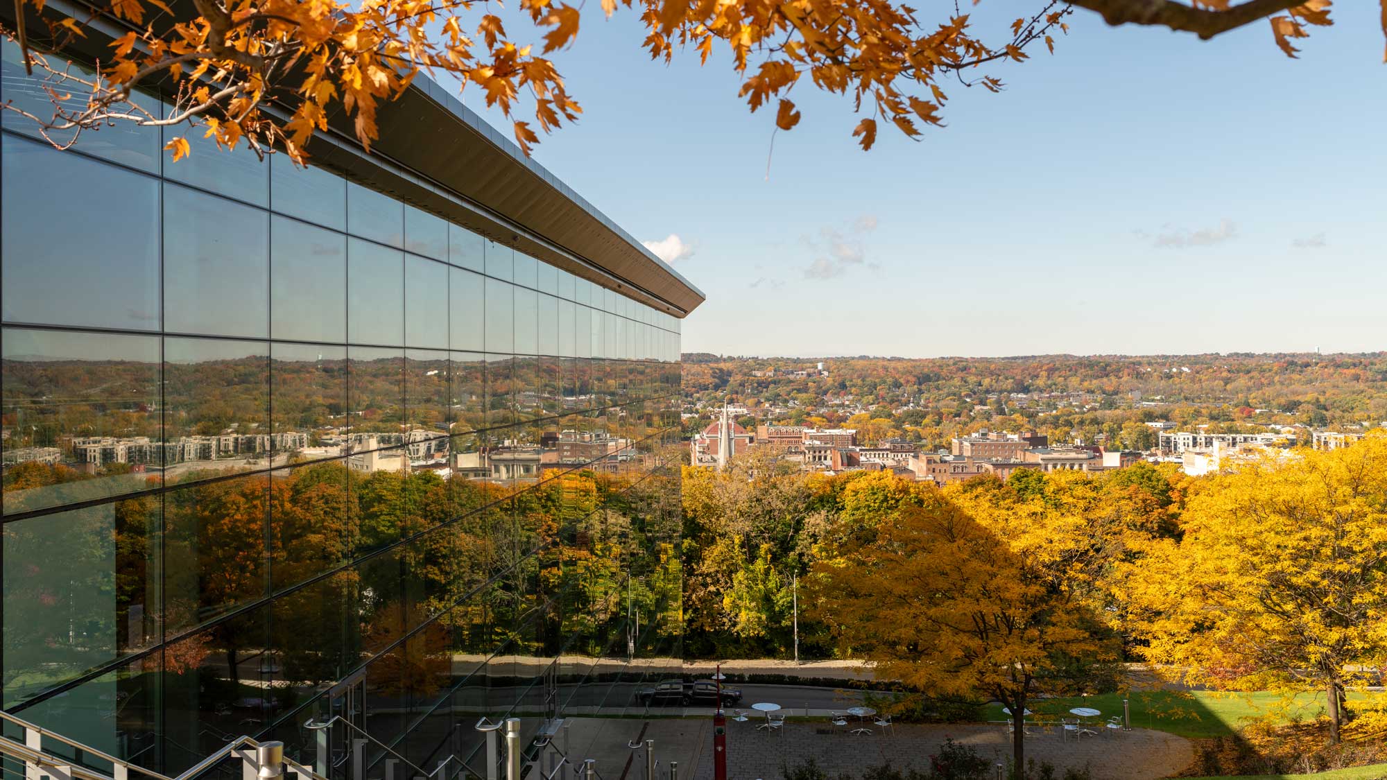 EMPAC's north façade reflects the city of troy looking west during fall.
