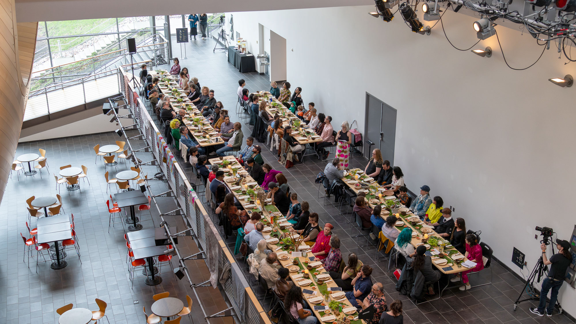 a long table meal on a mezzanine of an open building