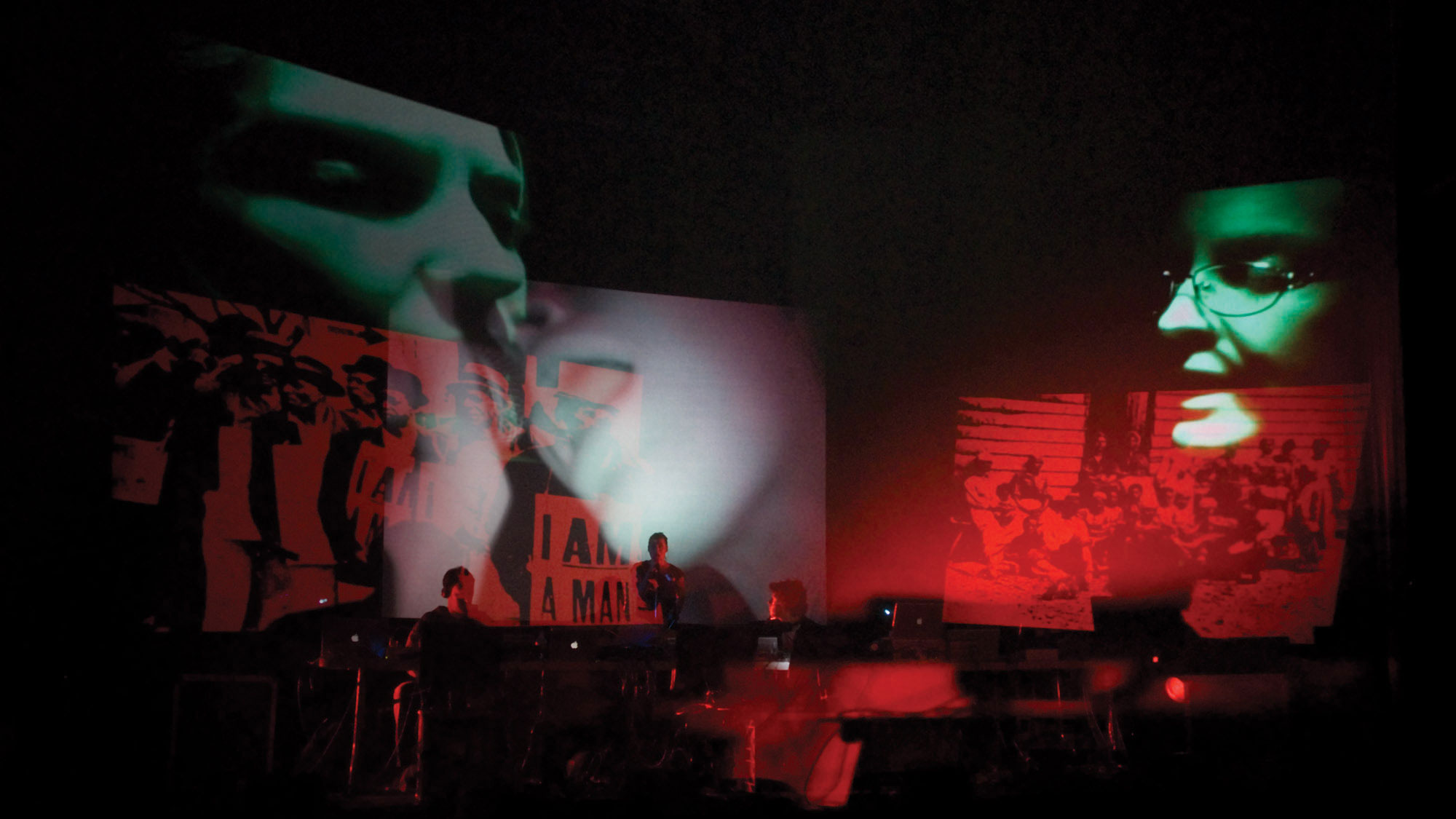 Layered projections of three individual pictures of people's face's in green over three images of people protesting in red. 