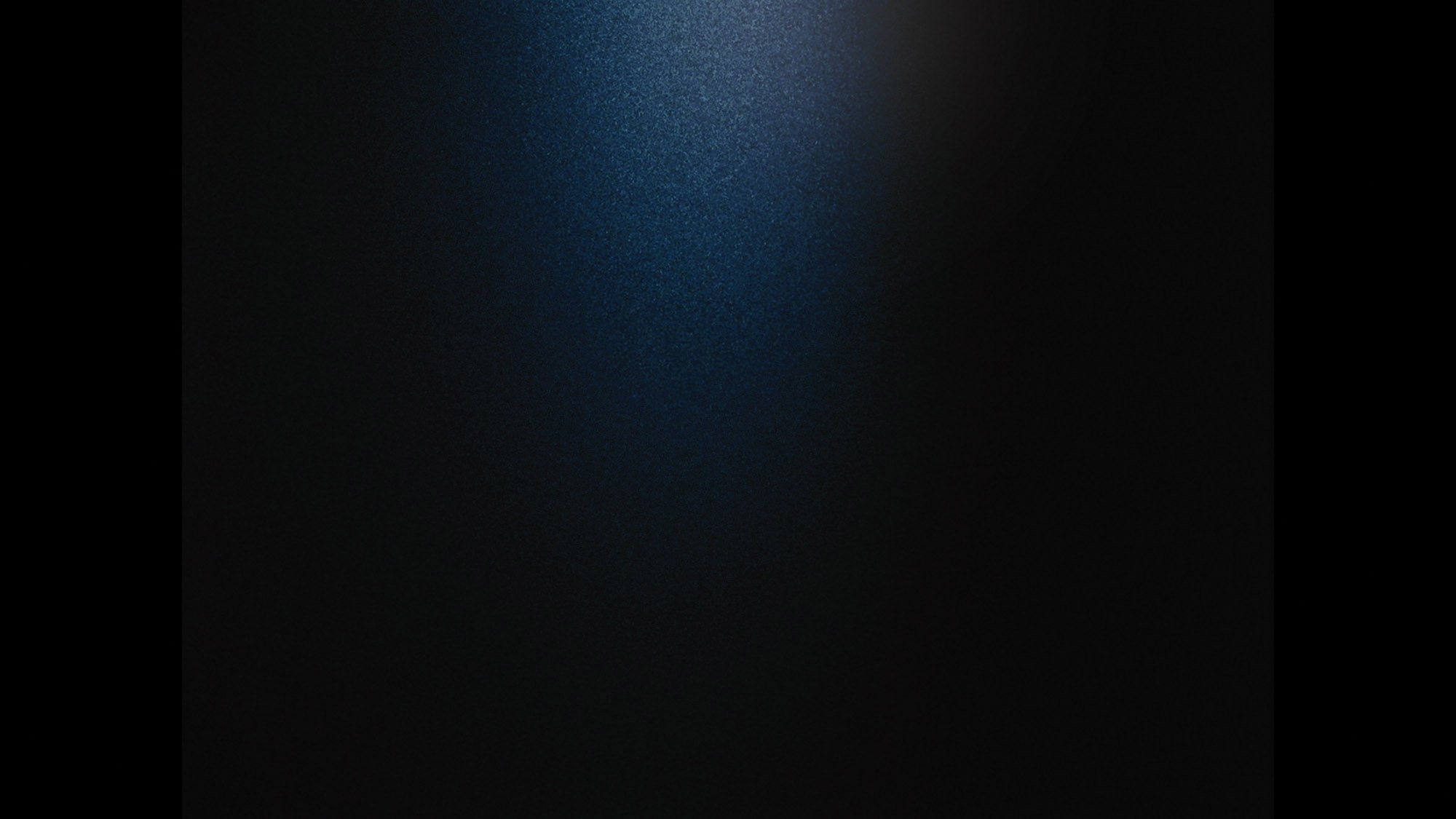 A black screen with a slight beam of light in the center. 