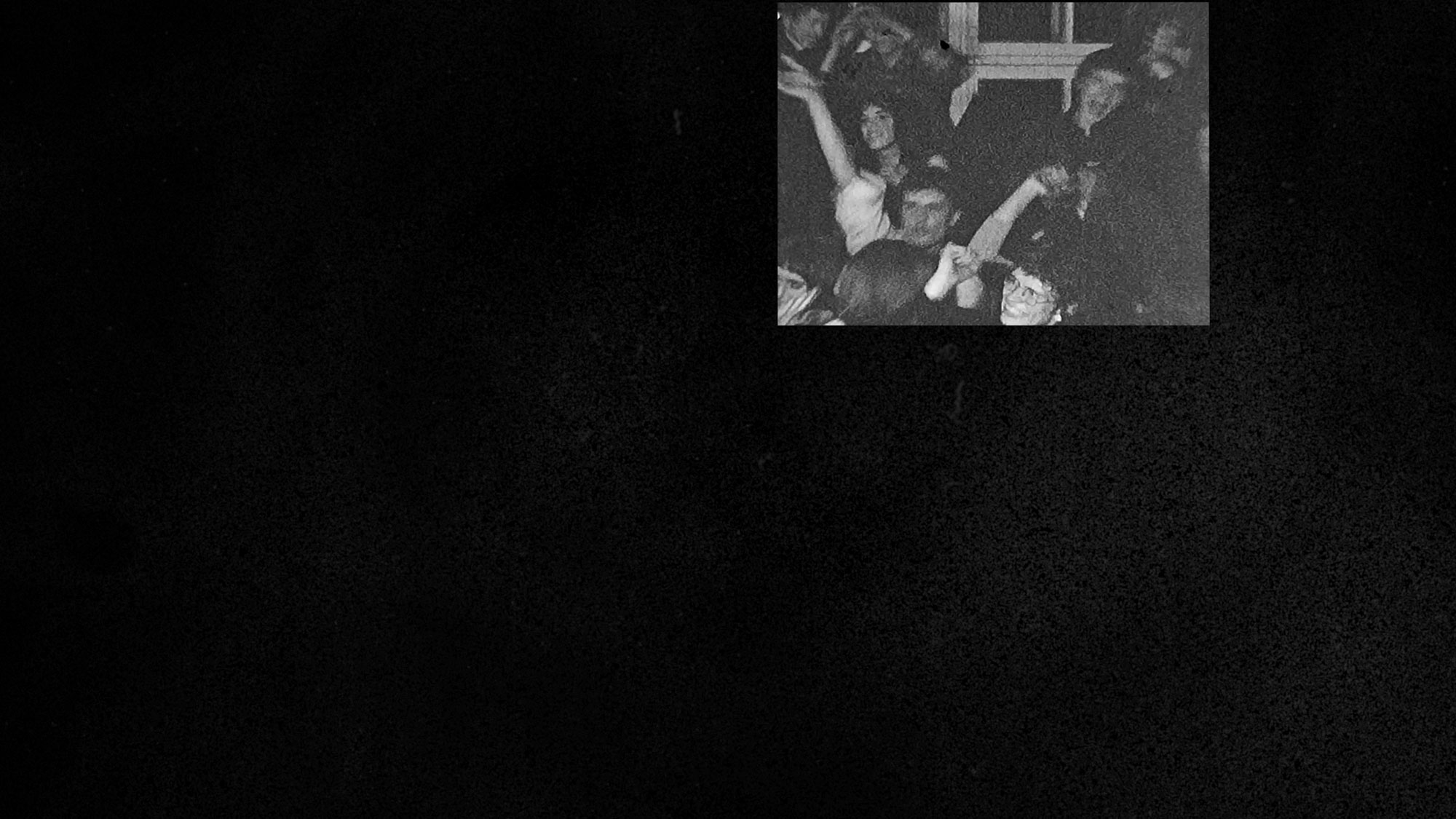 A black screen with a small film still in the upper right corner or a group of people with arms up and smiling. 