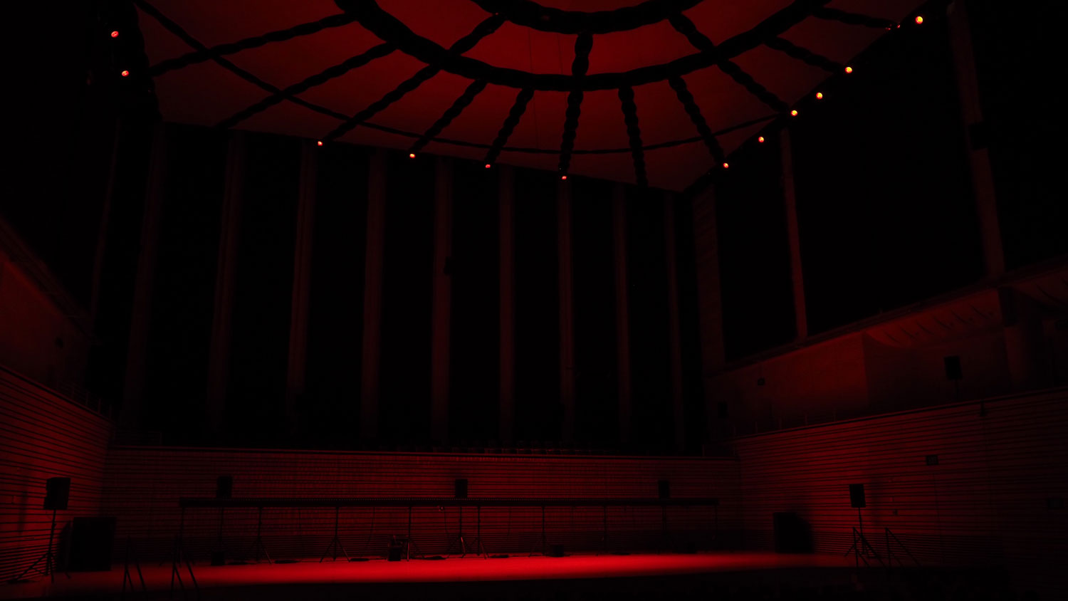 the concert hall bathed in deep red