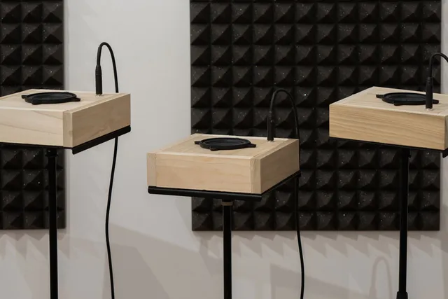 three square speakers on a pedestals