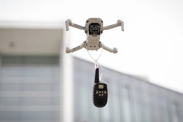a drone flying with a walkie talkie