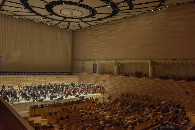 ASO's full orchestra on EMPAC's concert hall stage with a large audience.