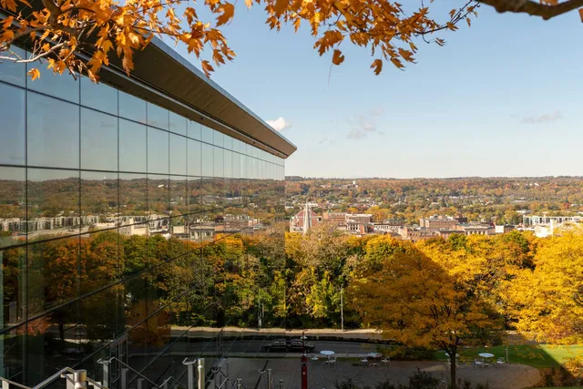 EMPAC's north façade reflects the city of troy looking west during fall.
