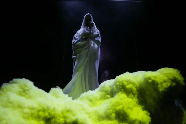 a ghostly figure standing in a green cloud