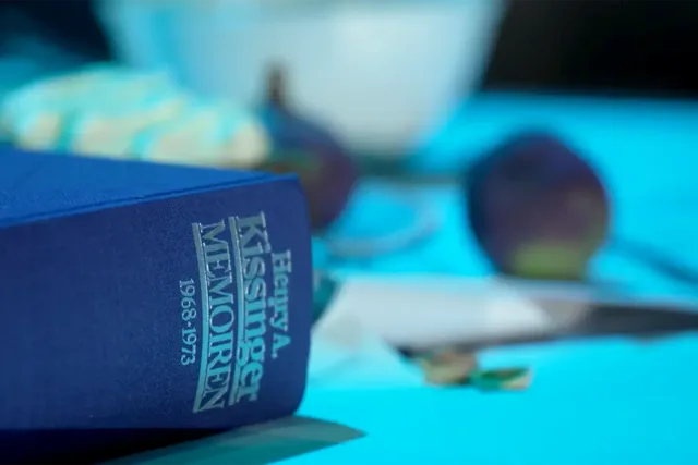 a close up of a table with a blue book 