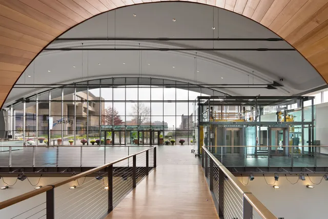 a large lobby bathed in natural light coming through glass walls.