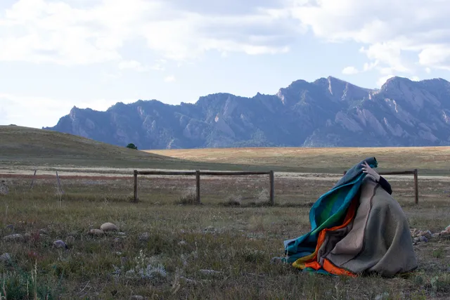 a mountainous landscape with a valley in the foreground 
