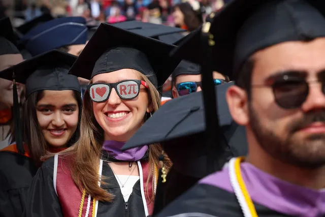 students lined up for graduation in cap and gown