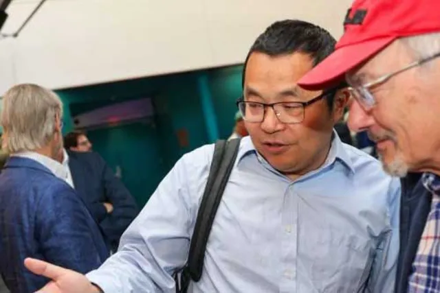 two men looking to their left in conversation