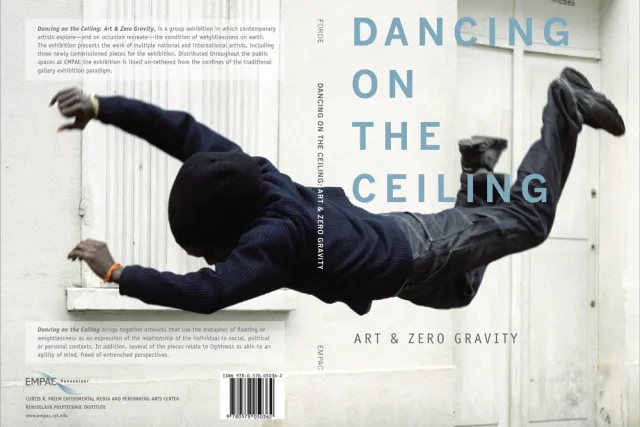 A man wearing a hoodie and jeans falling through space, against a white background. Blue text reads "Dancing on the Ceiling" 
