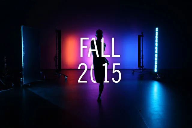a female figure silhouetted against red, magenta, and blue lights, Fall 2015. 