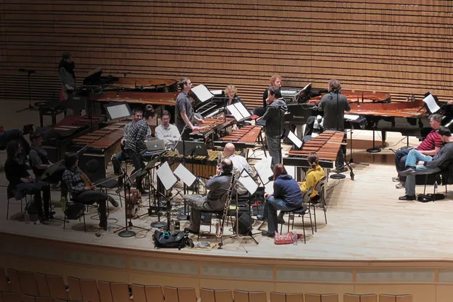 An ensemble practicing on the concert hall stage. 