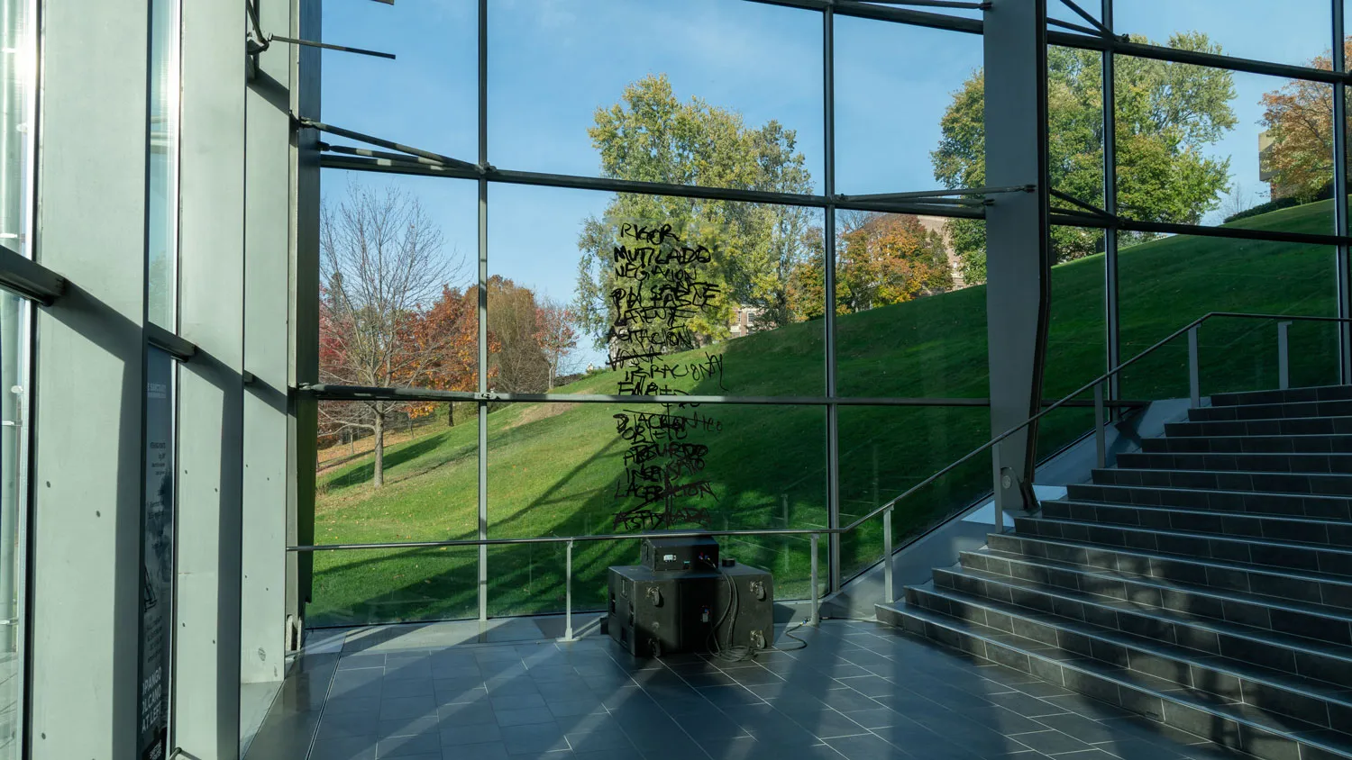 a pair of speakers facing a glass curtain wall in the empac building