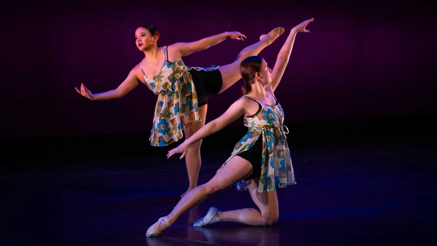 two women dancers on stage in ballet-like poses