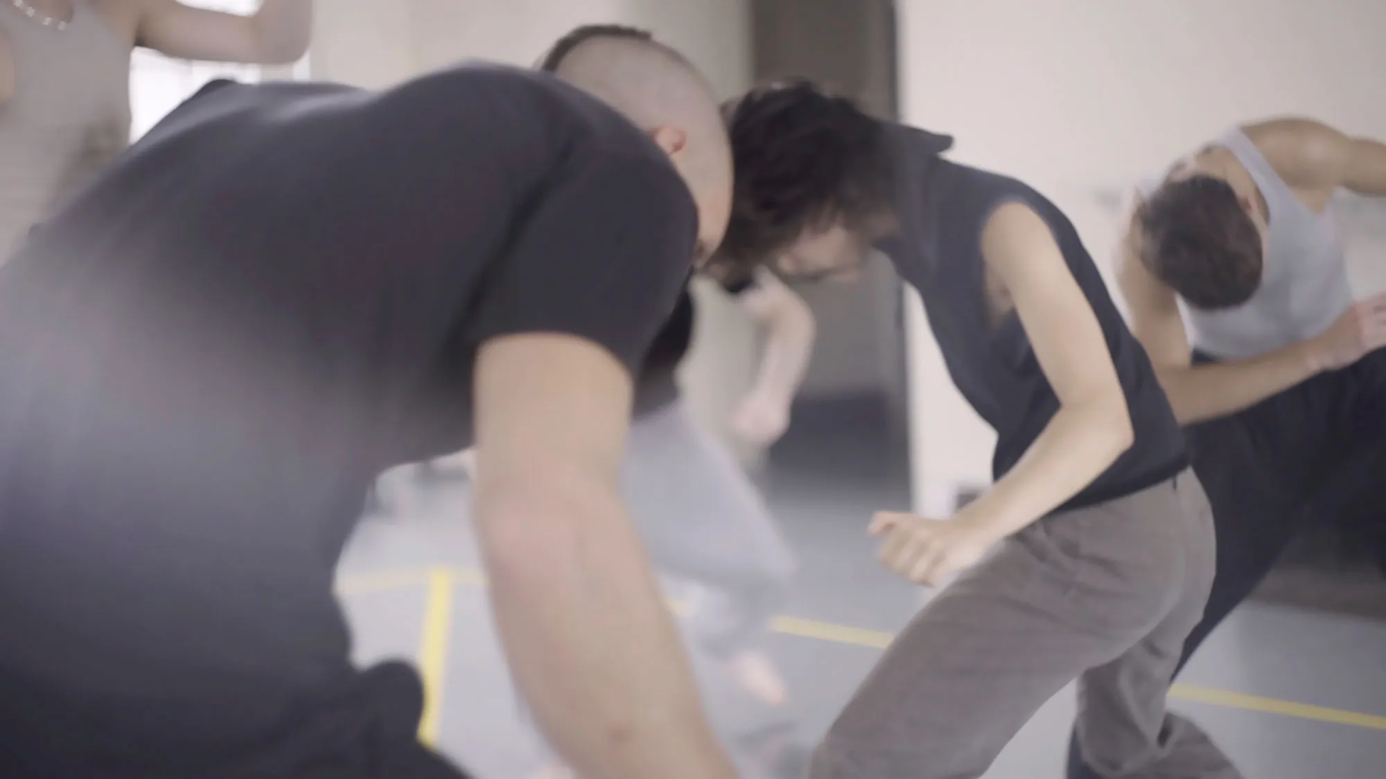 three people bent over in a room