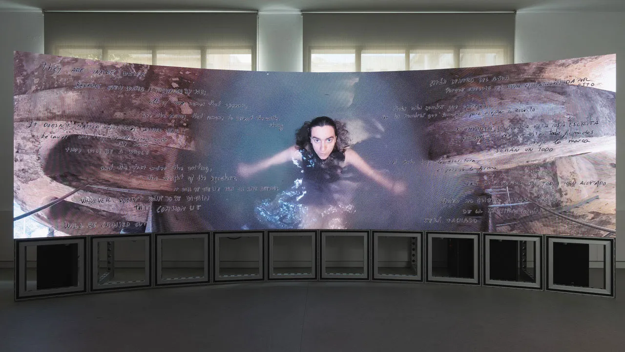 a parabolic screen with a woman treading water in the center