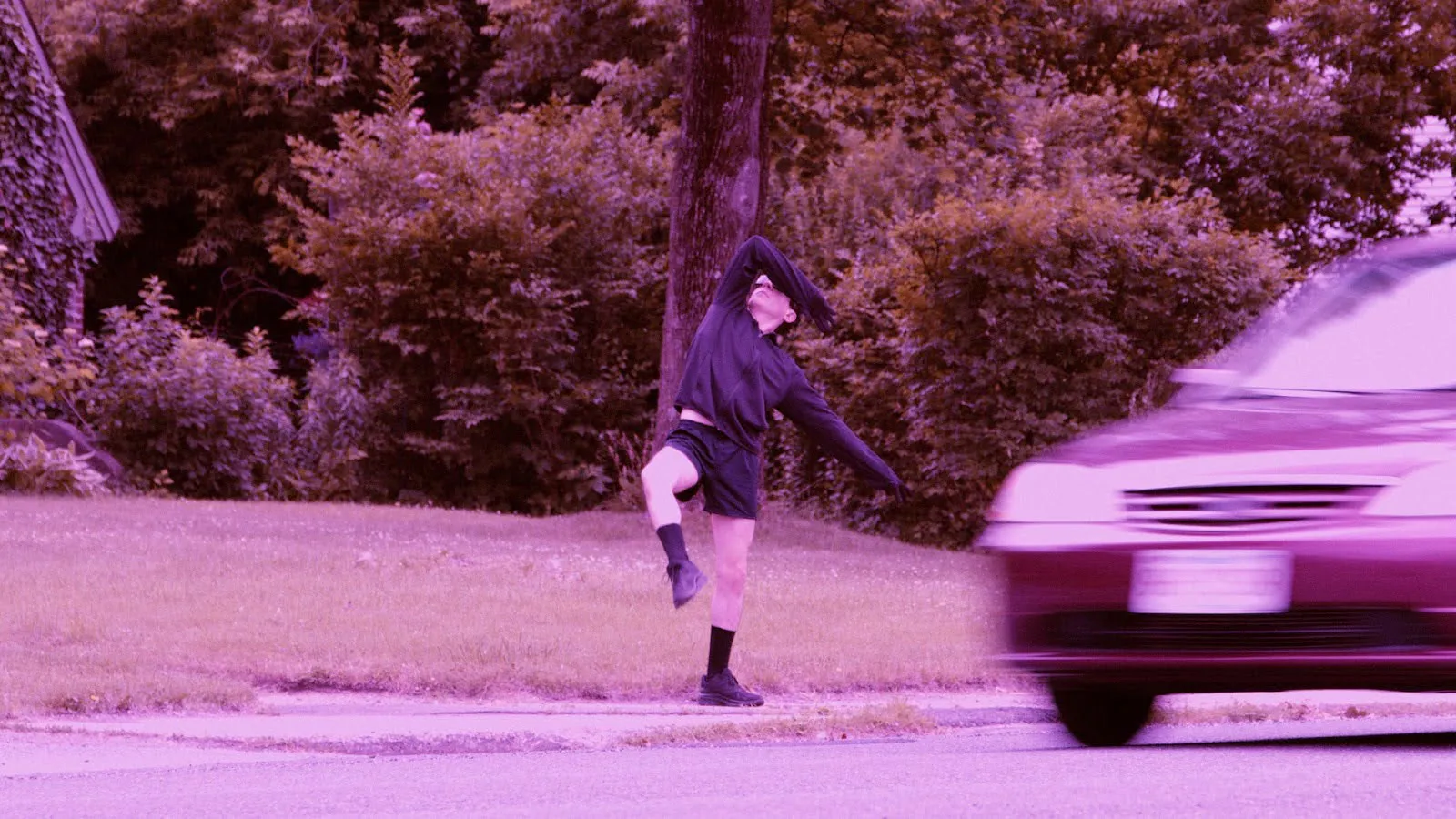 a man dancing on the side of a road