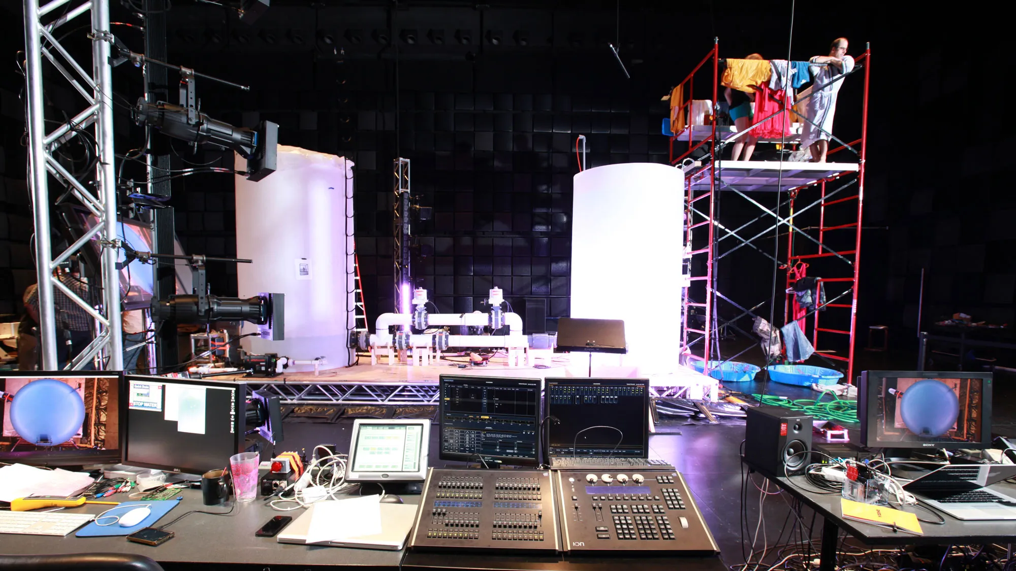 a huge plumbing and tank apparatus in production in a black box studio