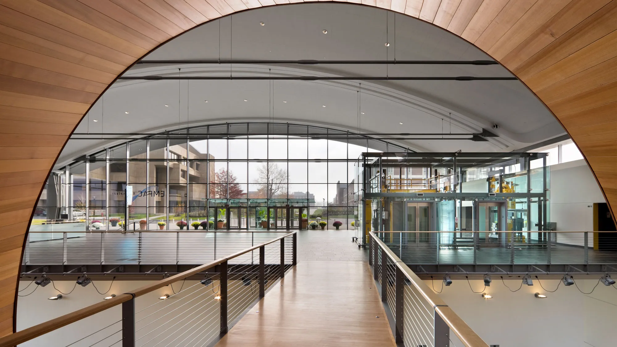 a large lobby bathed in natural light coming through glass walls.