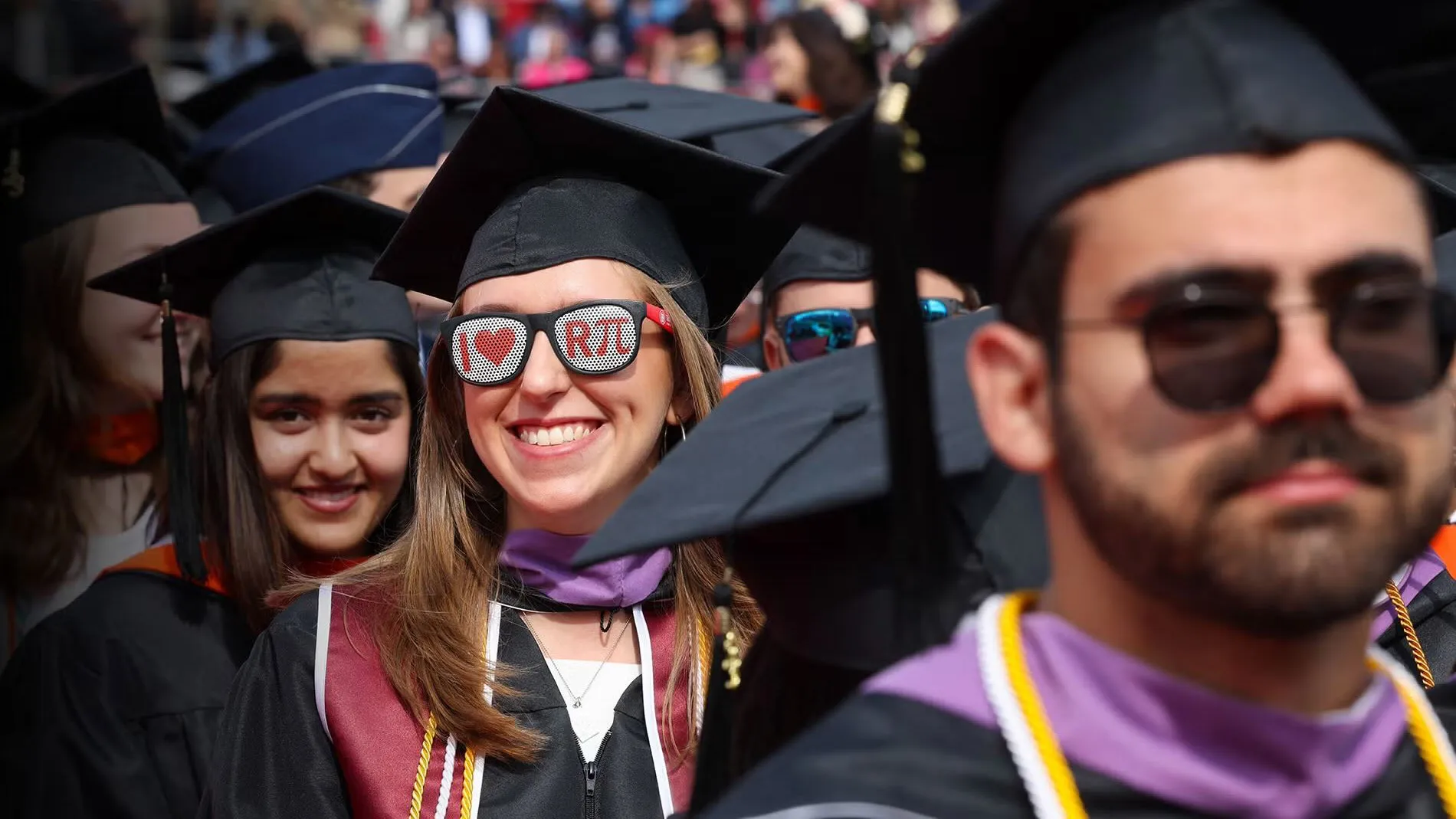 students lined up for graduation in cap and gown