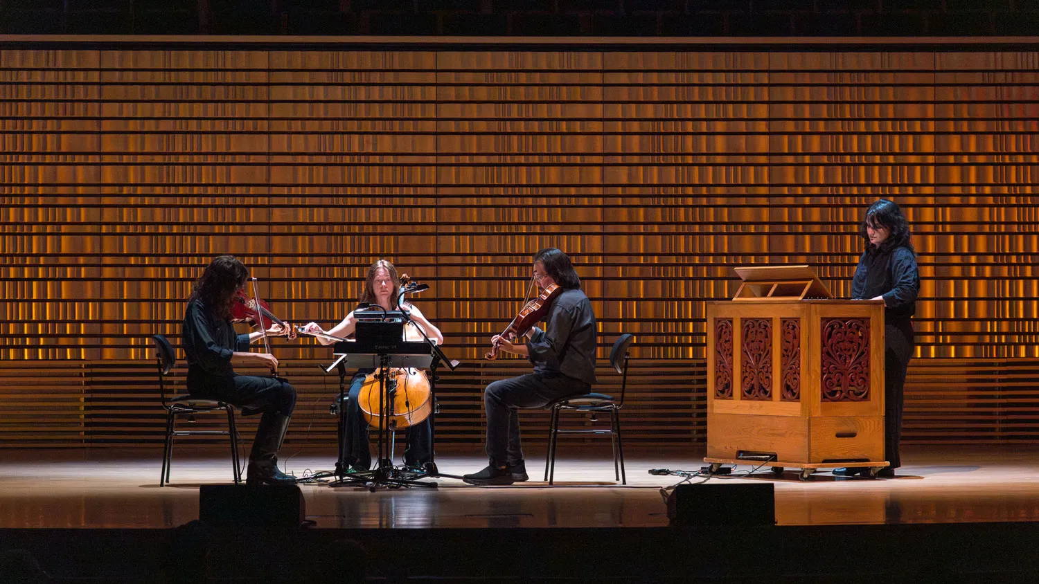 a quartet on a concert hall stage.