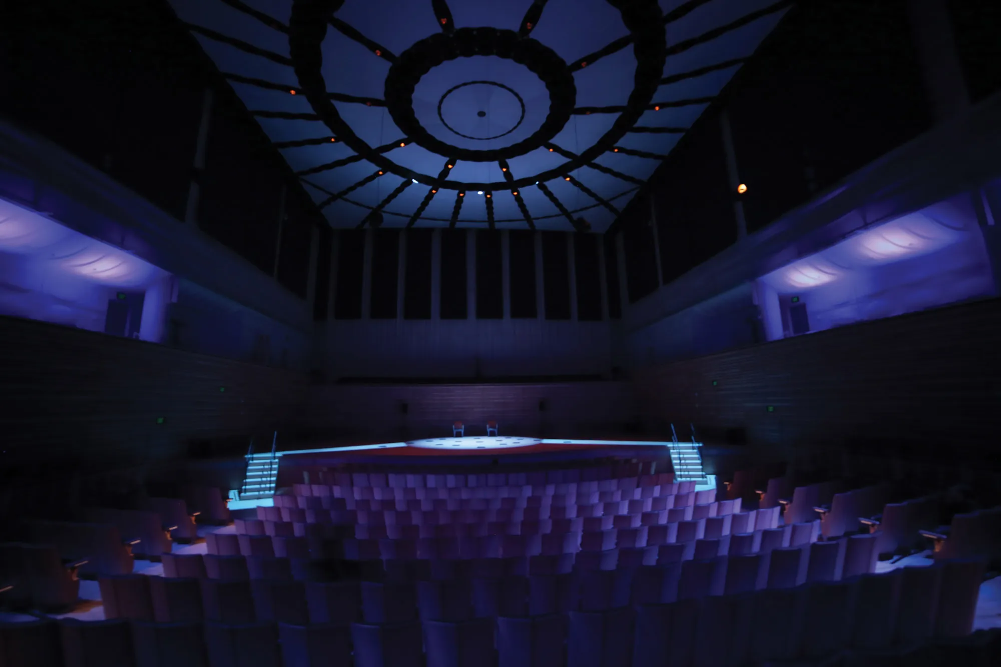 The concert hall washed in purple lighting 