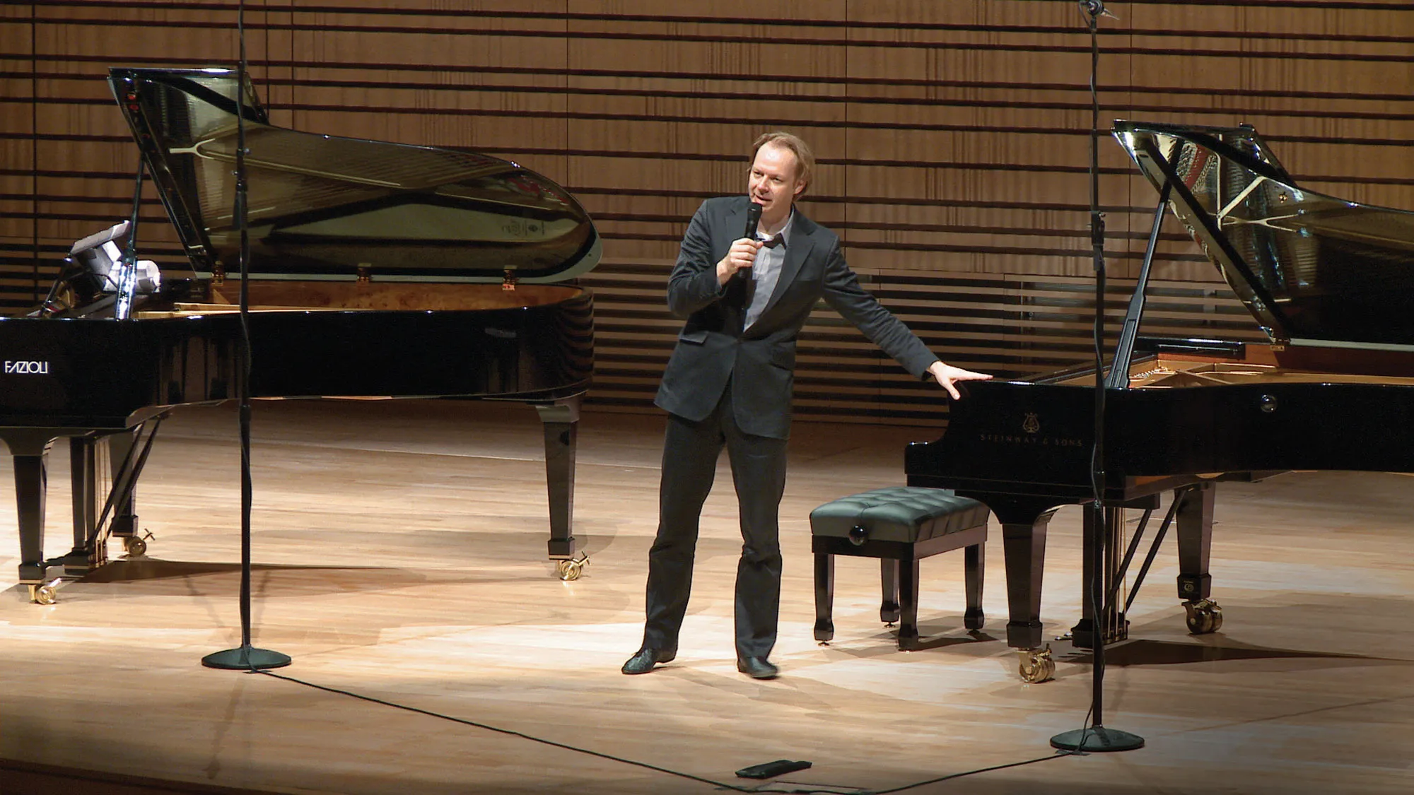 Per Tengstrand standing between two pianos on the concert hall stage.  