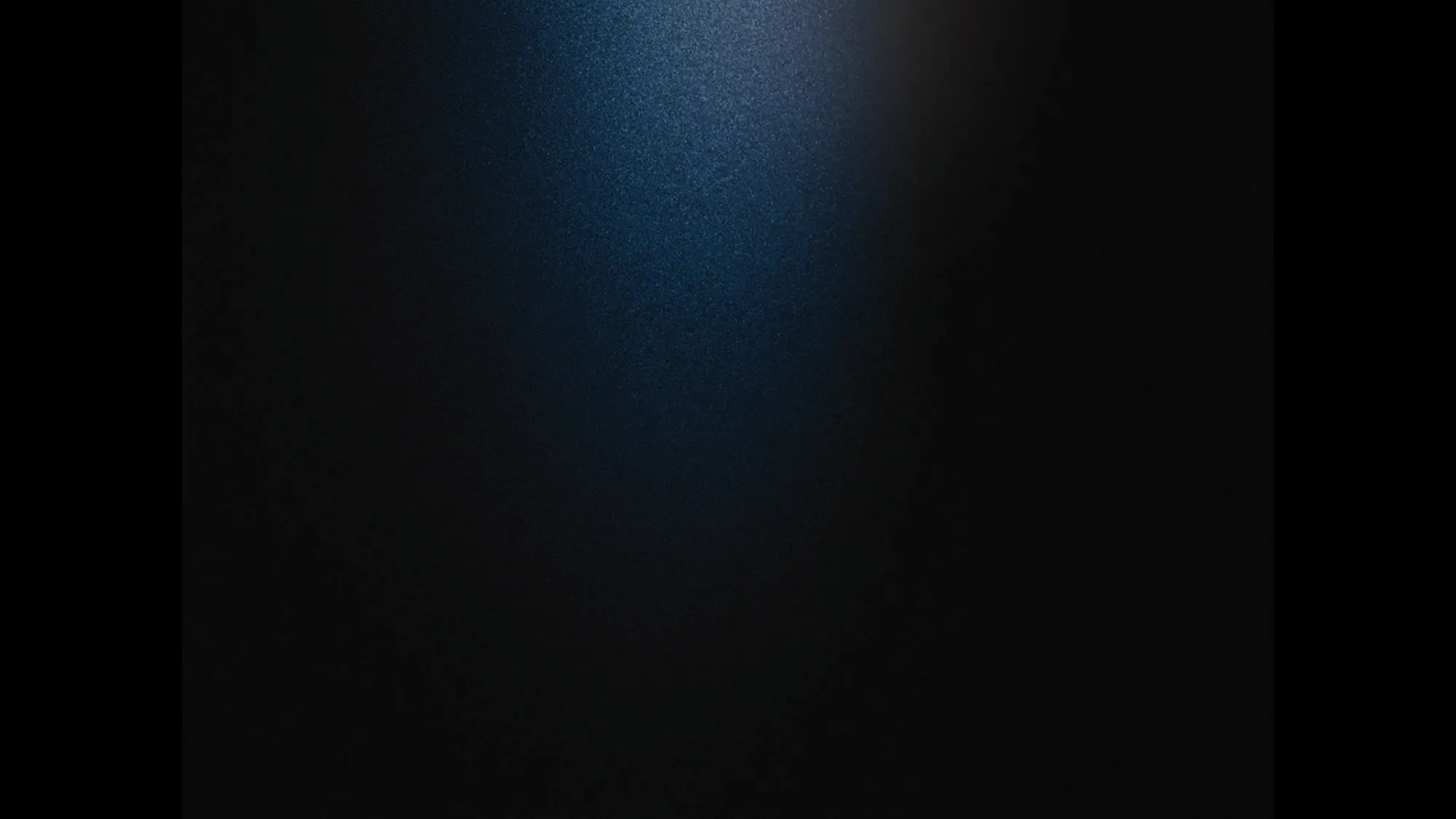 A black screen with a slight beam of light in the center. 